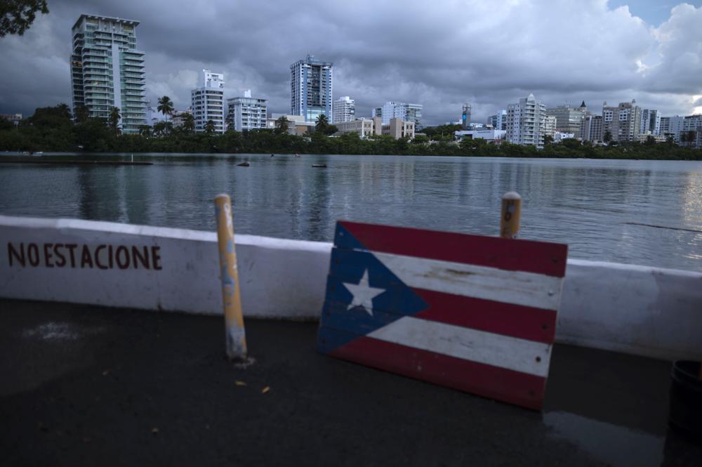 A wooden Puerto Rican flag is displayed on the dock of the Condado lagoon, where multiple selective blackouts have been recorded in the past days, in San Juan, Puerto Rico, Thursday, Sept. 30, 2021. Power outages across the island have surged in recent weeks, with some lasting up to several days. (AP Photo/Carlos Giusti)