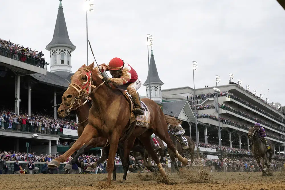FILE - Rich Strike, with Sonny Leon aboard, crosses the finish line to win the 148th running of the Kentucky Derby horse race at Churchill Downs Saturday, May 7, 2022, in Louisville, Ky. Rich Strike's stunning upset victory in last year's Kentucky Derby as a nearly 81-1 long shot provided the race's second biggest odds winner in four years. (AP Photo/Jeff Roberson, File)