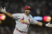 St. Louis Cardinals designated hitter Albert Pujols (5) watches after hitting a home run during the fourth inning of a baseball game against the Los Angeles Dodgers in Los Angeles, Friday, Sept. 23, 2022. Brendan Donovan and Tommy Edman also scored. It was Pujols' 700th career home run. (AP Photo/Ashley Landis)
