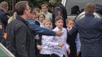 In this image taken from video, school children run from the scene of a shooting at school No. 88 in Izhevsk, Russia, Monday, Sept. 26, 2022. Authorities say a gunman has killed 15 people and wounded 24 others in the school in central Russia. According to officials, 11 children were among those killed in the Monday morning shooting. (Izhlife.ru via AP)