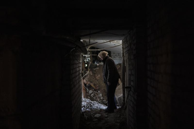 Lilia stands next to a place where a bomb heavily damaged the basement of a residential building killing, according to the residents, a 8-year-old girl during a Russian attack yesterday, in Lyman, Ukraine, Tuesday, April 26, 2022. Russia pounded eastern and southern Ukraine on Tuesday as the U.S. promised to "keep moving heaven and earth" to get Kyiv the weapons it needs to repel the new offensive, despite Moscow's warnings that such support could trigger a wider war. (AP Photo/Leo Correa)