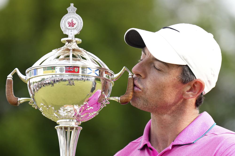 Rory McIlroy, of Northern Ireland, kisses the trophy after winning the final round of the Canadian Open golf tournament at St. George's Golf and Country Club in Toronto,  Sunday, June 12, 2022. (Nathan Denette/The Canadian Press via AP)