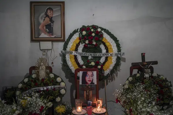 Photographs of Monica Citlalli Diaz are displayed during her wake inside her home in San Salvador Atenco, State of Mexico, Mexico, Thursday, Nov. 10, 2022. The 30-year-old English teacher became the ninth apparent femicide during an 11-day spate of killings in and around Mexico City from late October to early November. (AP Photo/Eduardo Verdugo)