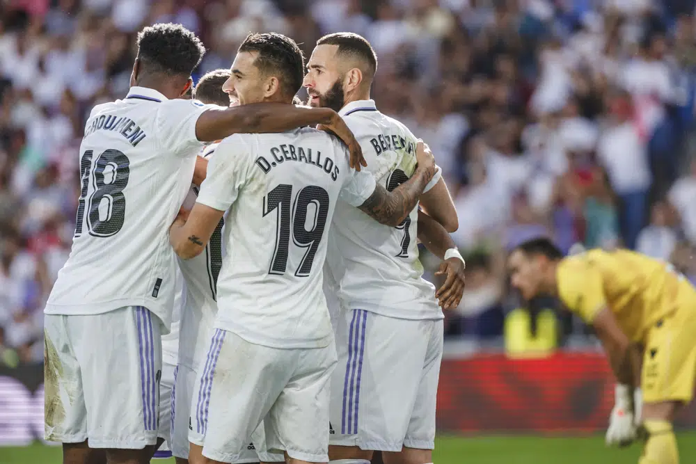 Real Madrid's Karim Benzema, centre, celebrates with team mates after scoring his side's 2nd goal during a Spanish La Liga soccer match between Real Madrid and Almeria at the Santiago Bernabeu stadium in Madrid, Spain, Saturday, April 29, 2023. (AP Photo/Pablo Garcia)