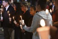 People attend a candlelight vigil for victims of a fatal shooting held at Ali Youssefi Square in Sacramento, Calif., late Monday, April 4, 2022. Multiple people were killed and injured after the shooting that occurred early Sunday. (Jose Carlos Fajardo/Bay Area News Group via AP)