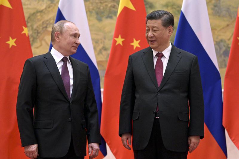 FILE - Chinese President Xi Jinping, right, and Russian President Vladimir Putin talk to each other during their meeting in Beijing, Friday, Feb. 4, 2022. Following this month’s meeting in Beijing between Russian leader Vladimir Putin and China’s Xi Jinping, speculation has risen over whether a new alliance could form between the two superpowers locked in competition with the U.S. (Alexei Druzhinin, Sputnik, Kremlin Pool Photo via AP, File)