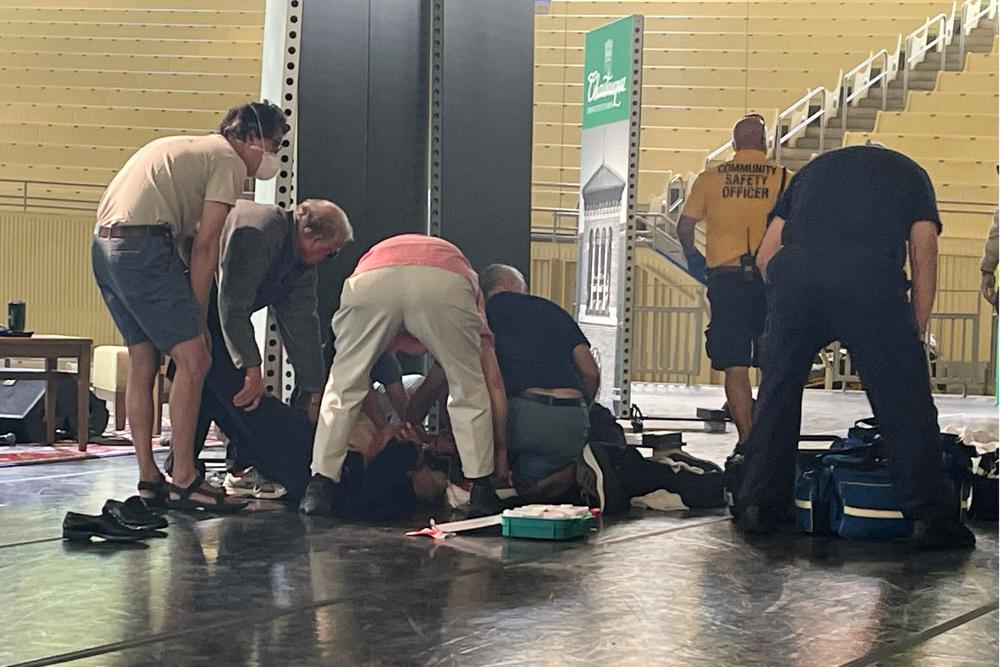 Author Salman Rushdie is tended to after he was attacked during a lecture, Friday, Aug. 12, 2022, at the Chautauqua Institution in Chautauqua, N.Y., about 75 miles (120 km) south of Buffalo. (AP Photo/Joshua Goodman)