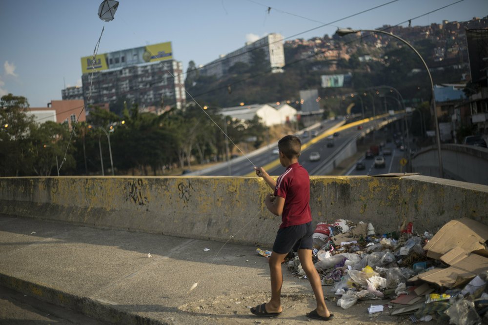 A boy flies a kite in Caracas, Venezuela, Tuesday, Feb. 5, 2019. Earlier this year, opposition leader Juan Guaidó launched a bold campaign with the support of the U.S. and more than 50 nations to oust Chávez’s successor, President Nicolás Maduro. However, Guaidó has yet to make good on his promises to restore democracy, spark a robust economy and make the streets safer. (AP Photo/Rodrigo Abd)