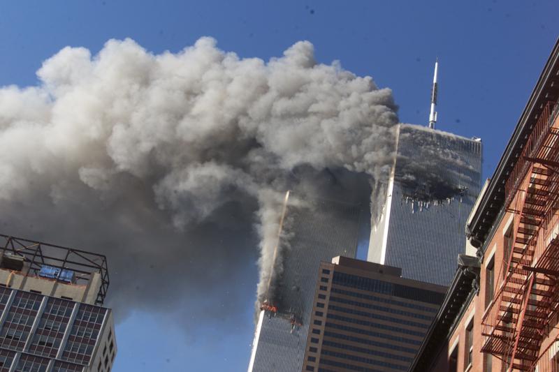 FILE - Smoke rises from the burning twin towers of the World Trade Center after hijacked planes crashed into the towers on September 11, 2001 in New York City.  Associated Press photographer Richard Drew talks about AP’s coverage of 9/11 and the events that followed. (AP Photo/Richard Drew)