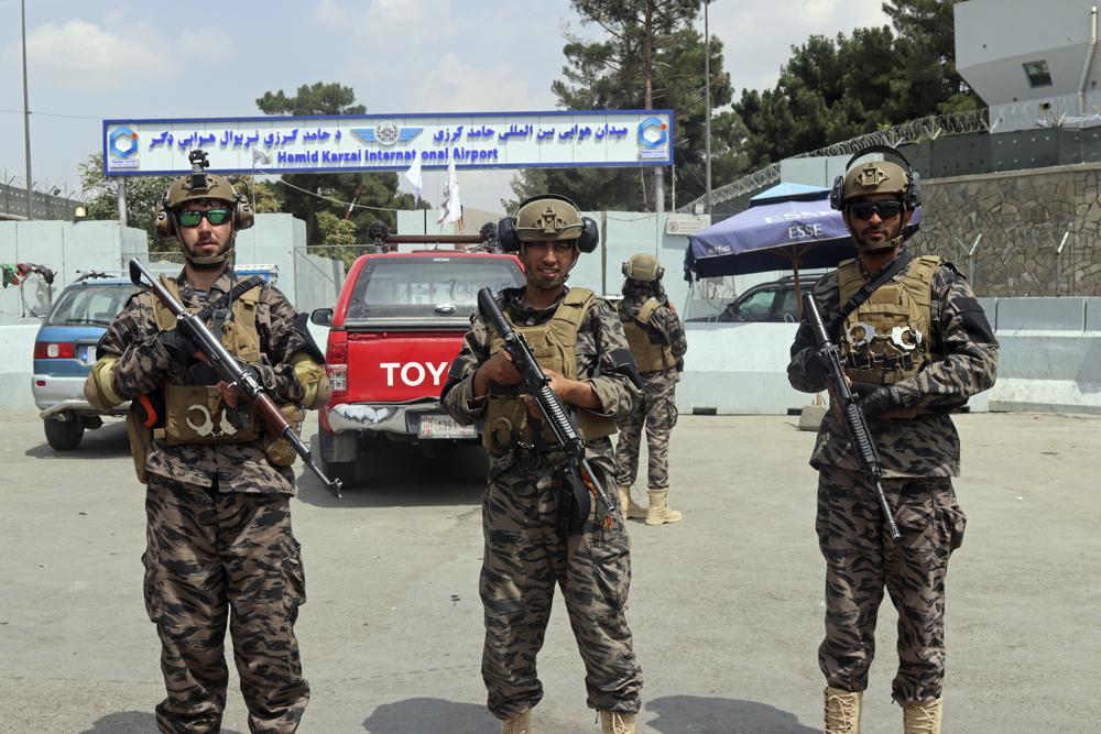 FILE - In this Tuesday, Aug. 31, 2021 file photo, Taliban special forces fighters stand guard outside the Hamid Karzai International Airport after the U.S. military's withdrawal, in Kabul, Afghanistan. The Taliban, which is in need of foreign aid, has said it will allow people with valid travel papers to leave, and the international community says it will be monitoring to see if they keep their word. (AP Photo/Khwaja Tawfiq Sediqi)