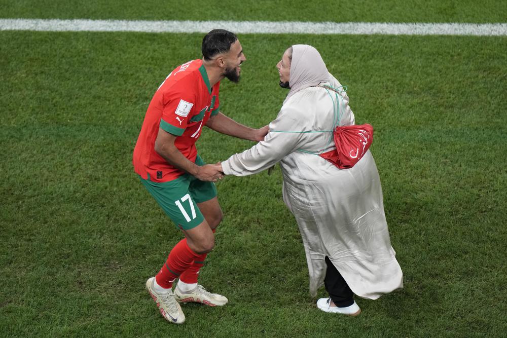 Morocco's Sofiane Boufal, left, celebrates with his mother after his team's win in the World Cup quarterfinal soccer match between Morocco and Portugal, at Al Thumama Stadium in Doha, Qatar, Saturday, Dec. 10, 2022. (AP Photo/Luca Bruno)