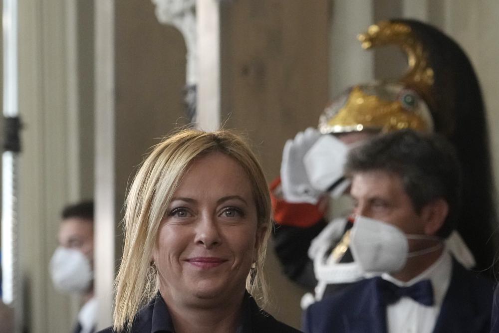 FILE - Brothers of Italy's leader Giorgia Meloni arrives at the Quirinale Presidential Palace after a meeting with Italian President Sergio Mattarella as part of a round of consultations with party leaders to try and form a new government, in Rome, on Oct. 21, 2022. As she becomes Italy's first female premier, with the world is watching closely to see if she will emerge as a firebrand leader of a far-right party with neo-fascist roots or the more moderate right-wing politician who captured 26% of the vote, Giorgia Meloni will also be facing issues such as the energy crisis, civil rights, EU recover-fund, economy and internal coalition tensions with her allies. (AP Photo/Gregorio Borgia, File)