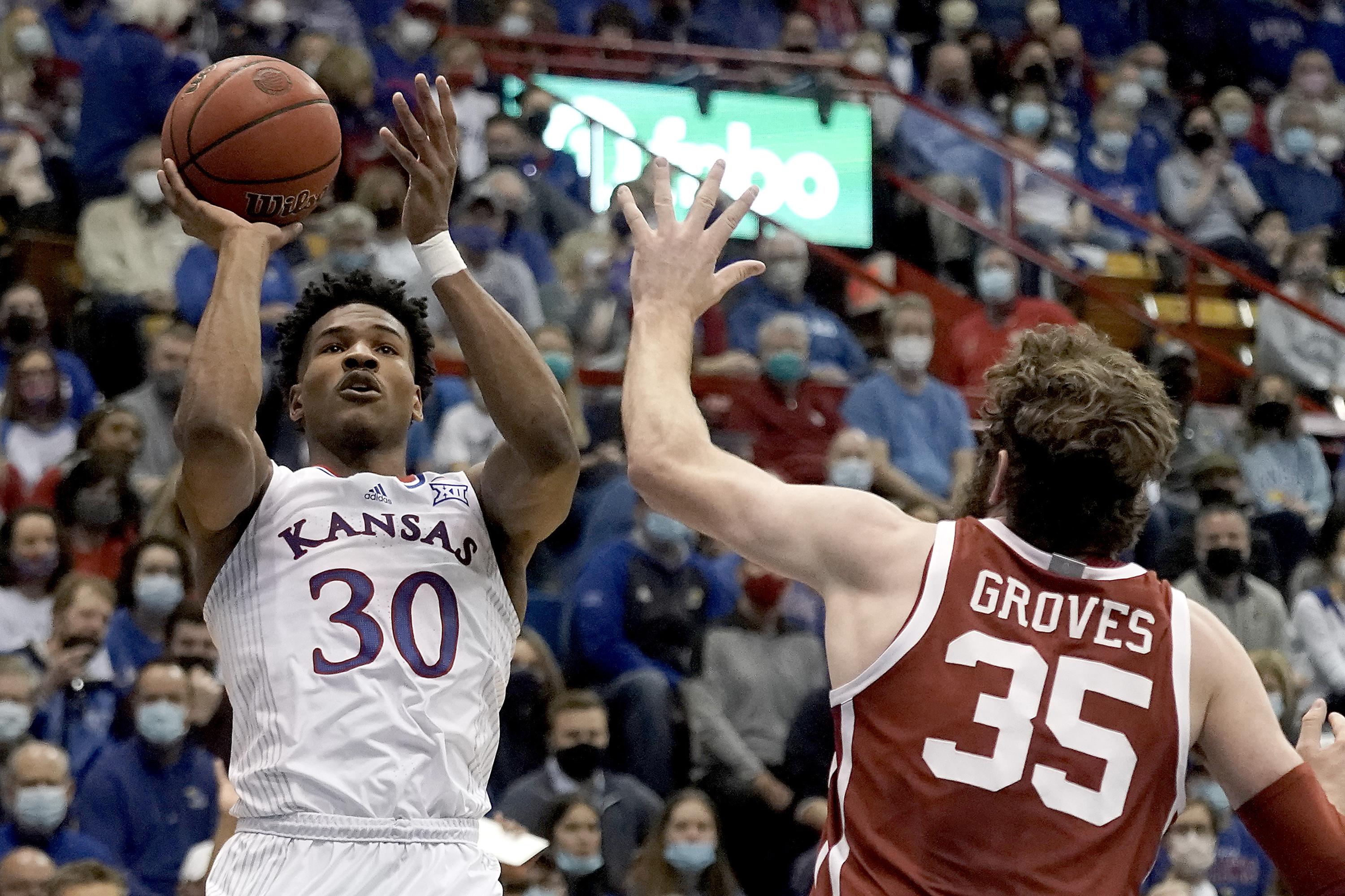 Wilson scores 20, No. 8 Kansas holds off Oklahoma 7169 AP News