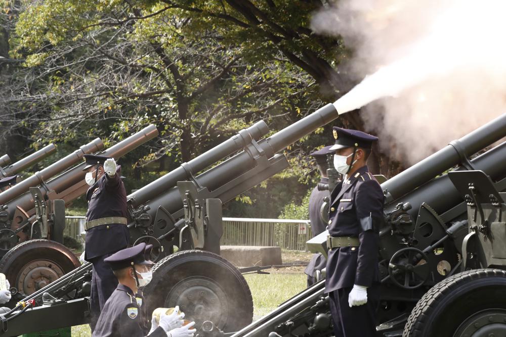 Japanese Ground Self-Defense Force personnel fire cannons at the Nippon Budokan grounds for the state funeral of former Prime Minister Shinzo Abe, in Tokyo Tuesday, Sept. 27, 2022. (Rodrigo Reyes Marin/Pool Photo via AP)