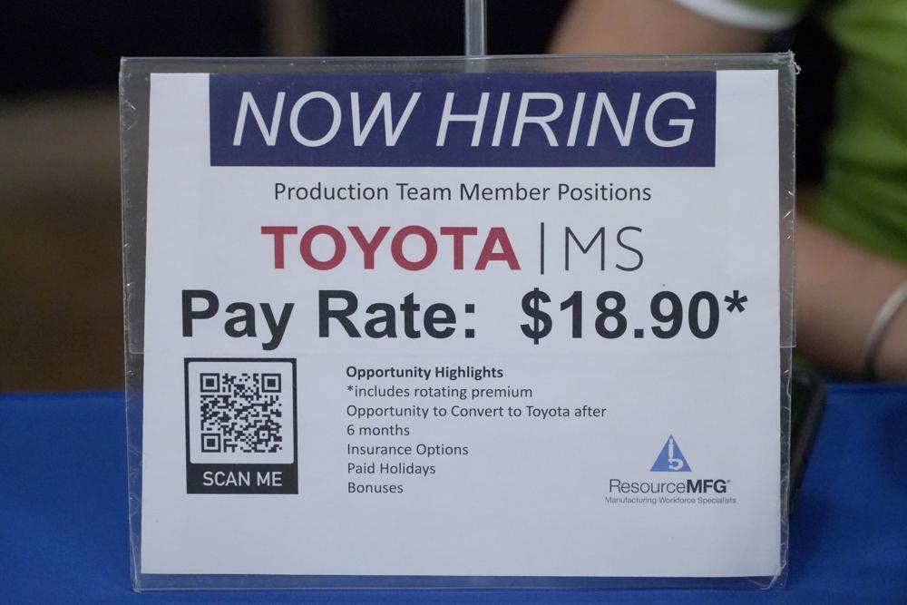 A workforce placement company outlines the pay and benefits that could be obtained should the applicant be placed at the Toyota Auto Manufacturing plant in Blue Springs, Miss., during the Lee County Area Job Fair in Tupelo, Miss., Tuesday, Oct. 12, 2021. Employers representing a variety of manufacturing, production, service industry, medical and clerical companies attended the day long affair with an eye towards recruitment, hiring, training and retention. (AP Photo/Rogelio V. Solis)