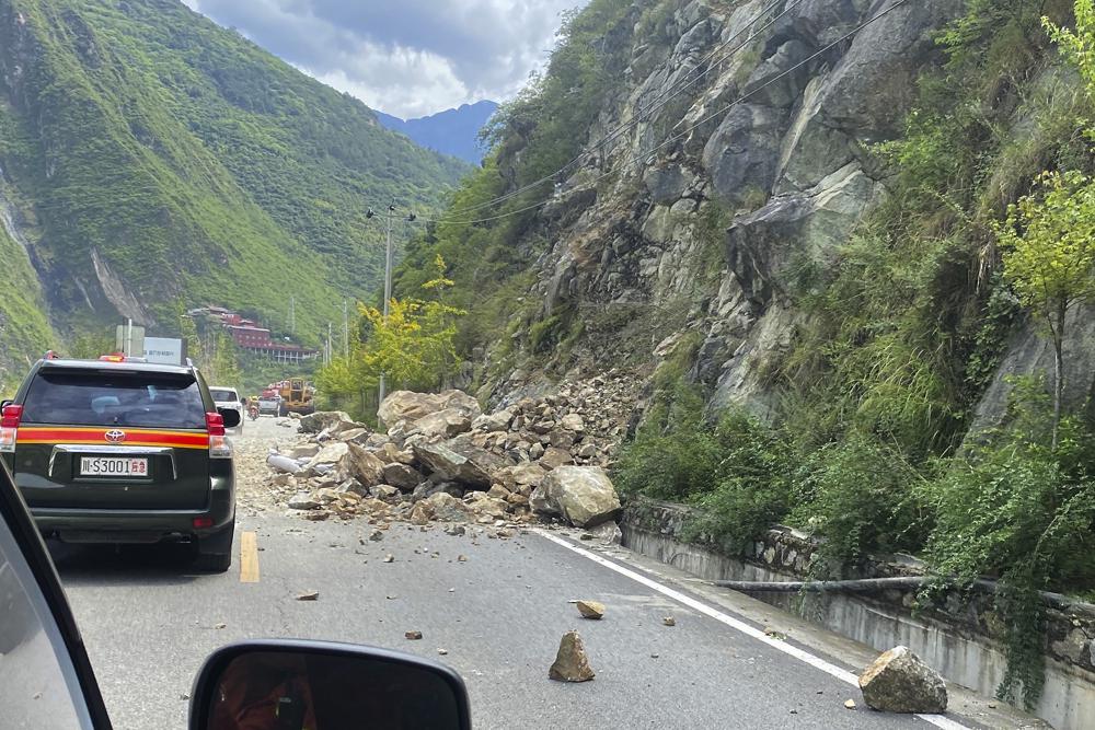 In this photo released by Xinhua News Agency, fallen rocks are seen on road heading to Luding county, the epicentre of a quake in southwest China's Sichuan Province, Monday, Sept. 5, 2022. Many people were reported killed in a 6.8 magnitude earthquake that shook China's southwestern province of Sichuan on Monday, triggering landslides and shaking buildings in the provincial capital of Chengdu, whose 21 million residents are already under a COVID-19 lockdown. (Xinhua via AP)