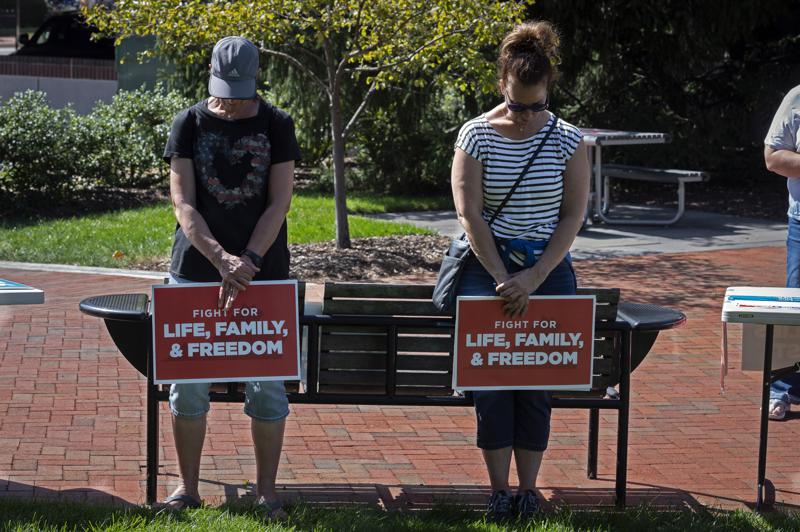 Demonstrators bow during a prayer at a rally sponsored by Catholic Vote and Fight for Schools, in Leesburg, Va., Saturday, Oct. 2, 2021. When Democrat Terry McAuliffe said during the Virginia governor’s debate last week that he doesn’t believe “parents should be telling schools what they should teach,” his opponent pounced. Republican Glenn Youngkin quickly turned the footage into a digital ad, then announced spending $1 million on a commercial airing statewide proclaiming that “Terry went on the attack against parents.” (AP Photo/Cliff Owen)