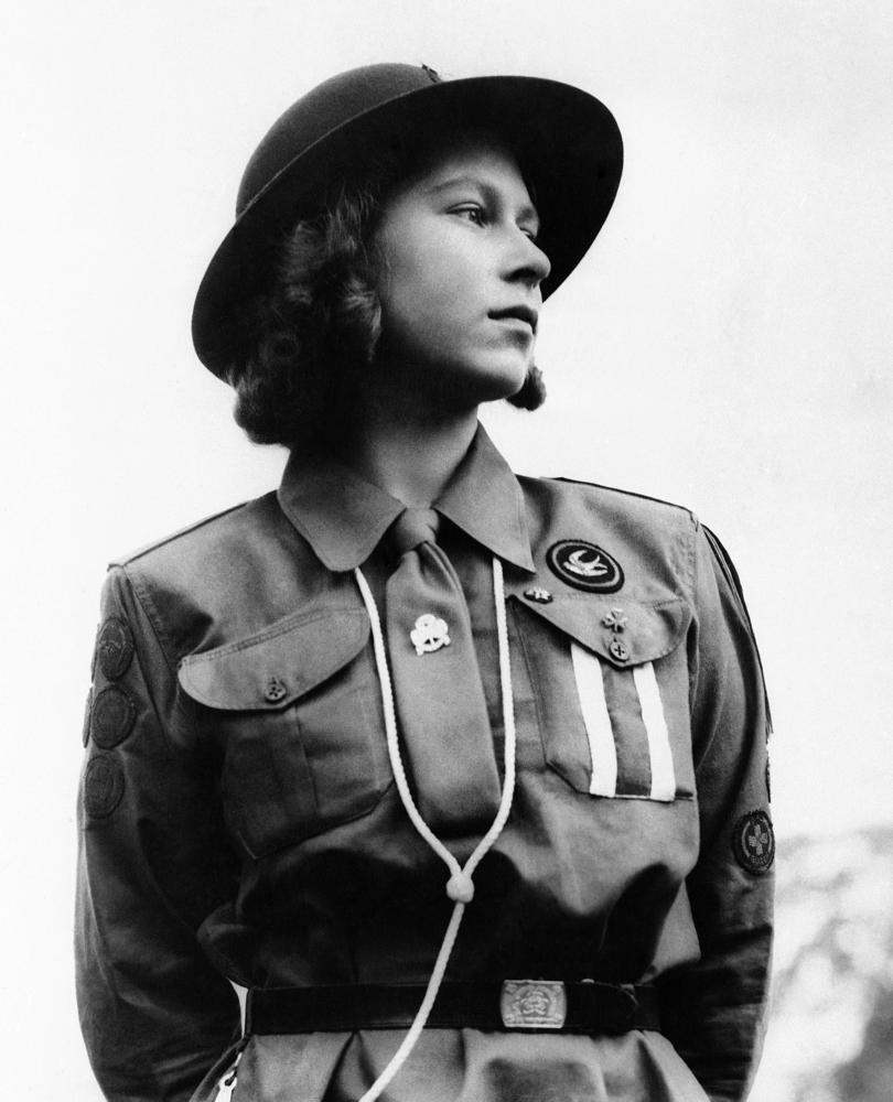 FILE - In this Aug. 17, 1943 file photo, Britain's Princess Elizabeth poses for a photo in a Girl Guides uniform, in Windsor Great Park, in Windsor, England.  Queen Elizabeth II, Britain’s longest-reigning monarch and a rock of stability across much of a turbulent century, has died. She was 96. Buckingham Palace made the announcement in a statement on Thursday Sept. 8, 2022. (AP Photo, File)