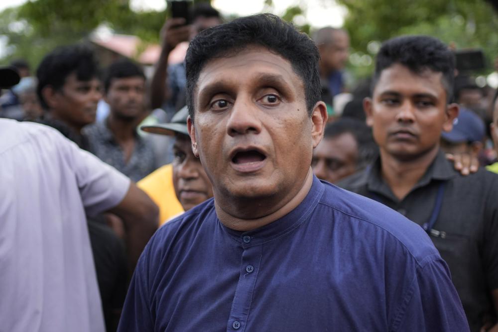 Sri Lanka's opposition leader Sajith Premadasa leaves an anti government protest march after a group of protesters opposed his presence in Colombo, Sri Lanka, Wednesday, Nov. 2, 2022. The protestors were demanding the release of two detained  protest leaders and to end the government’s crackdown on protests against an unprecedented economic crisis that has engulfed the island nation for months. (AP Photo/Eranga Jayawardena)