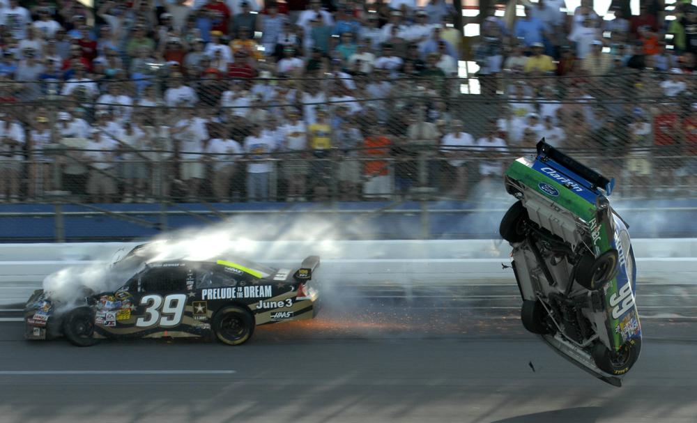 FILE -Carl Edwards flips after hitting Ryan Newman, left, on the last lap of the Aaron's 499 NASCAR Sprint Cup Series auto race at Talladega Superspeedway in Talladega, Ala. on Sunday, April 26, 2009. NASCAR’s next 75 years almost certainly will include at least a partially electric vehicle turning laps at Daytona International Speedway. It’s unfathomable to some, unconscionable to others. (AP Photo/Rainier Ehrhardt, File)