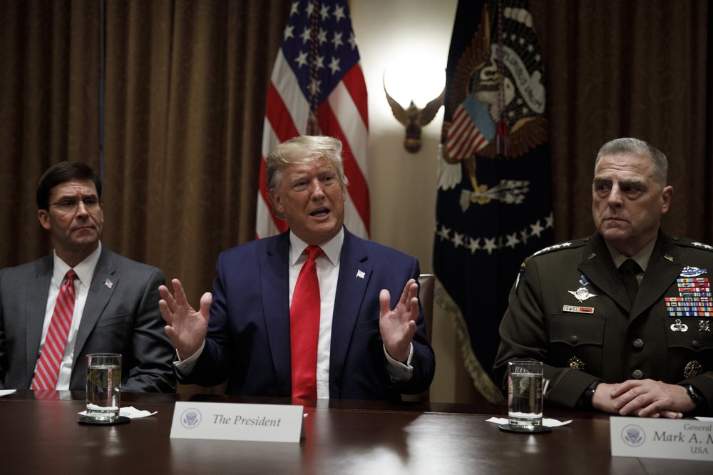 President Donald Trump, joined by from left, Defense Secretary Mark Esper, and Chairman of the Joint Chiefs of Staff Gen. Mark Milley, speaks to media during a briefing with senior military leaders in the Cabinet Room at the White House in Washington, Monday, Oct. 7, 2019. (AP Photo/Carolyn Kaster)