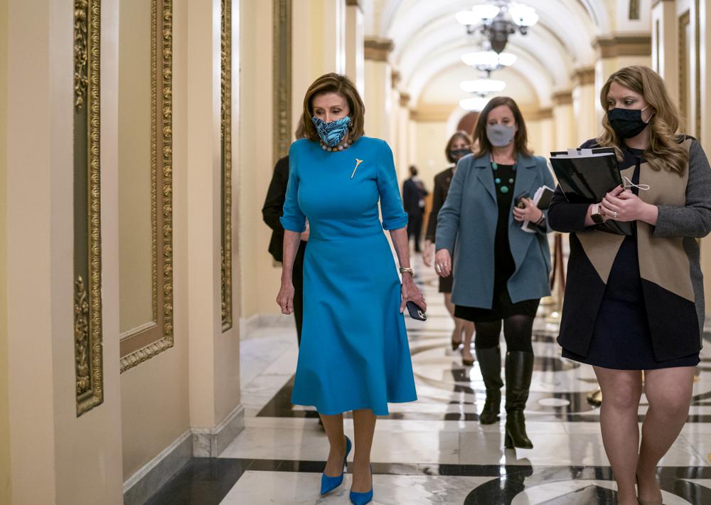 Speaker of the House Nancy Pelosi, D-Calif., leaves the chamber after midnight during a lengthy floor speech by House Minority Leader Kevin McCarthy, R-Calif., who disrupted a planned vote on President Joe Biden's domestic agenda, the Build Back Better Act, at the Capitol in Washington, early Friday, Nov. 19, 2021. (AP Photo/J. Scott Applewhite)