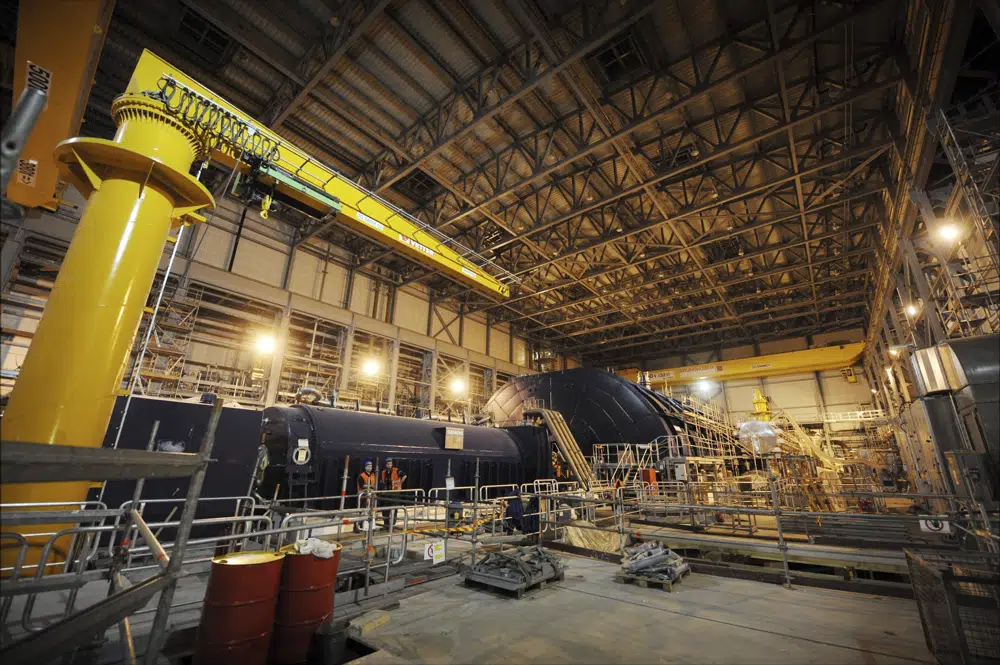 FILE - The turbine hall of the nuclear power plant Olkiluoto 3 'OL3' is pictured under construction in Eurajoki, south-western Finland, March 23, 2011. Finland’s much-delayed and costly new nuclear reactor, Europe's most powerful by production capacity, has completed a test phase lasting over a year and started regular output, boosting the Nordic country’s electricity self-sufficiency significantly. The Olkiluoto 3 reactor, which has 1,600-megawatt capacity, was connected into the Finnish national power grid in March 2022 and kicked off regular production on Sunday, April 16, 2023. (AP Photo/Lehtikuva, Antti Aimo-Koivisto, File)