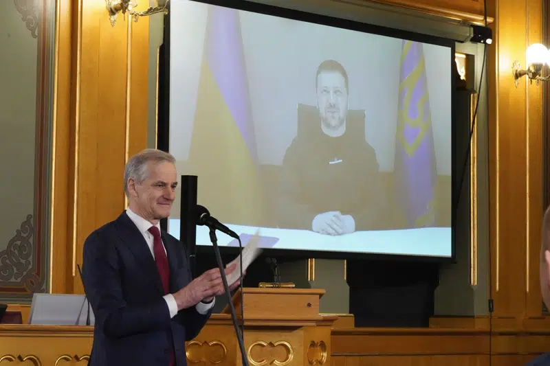 Norways Prime Minister Jonas Gahr Støre, presents the political agreement on the Ukraine program, with Ukrainian President Volodymyr Zelenskyy participation via video link, at the Norwegian parliament, in Oslo, Thursday, Feb. 16, 2023. Oil-rich Norway is looking to donate 75 billion kroner ($7.3 billion) to Kyiv as part of a five-year support package that would make the Scandinavian country one of the world’s biggest donors to war-torn Ukraine. (Terje Pedersen/NTB Scanpix via AP)
