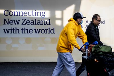 Los pasajeros llegan al Aeropuerto Internacional de Auckland, en Auckland, Nueva Zelanda, el miércoles 16 de marzo de 2022. La primera ministra de Nueva Zelanda, Jacinda Ardern, dice que su nación está "lista para dar la bienvenida al mundo de vuelta" y que a la mayoría de los turistas se les permite regresar en mayo, ya que la nación continúa aliviando sus restricciones por el coronavirus. (Michael Craig/New Zealand Herald vía AP)