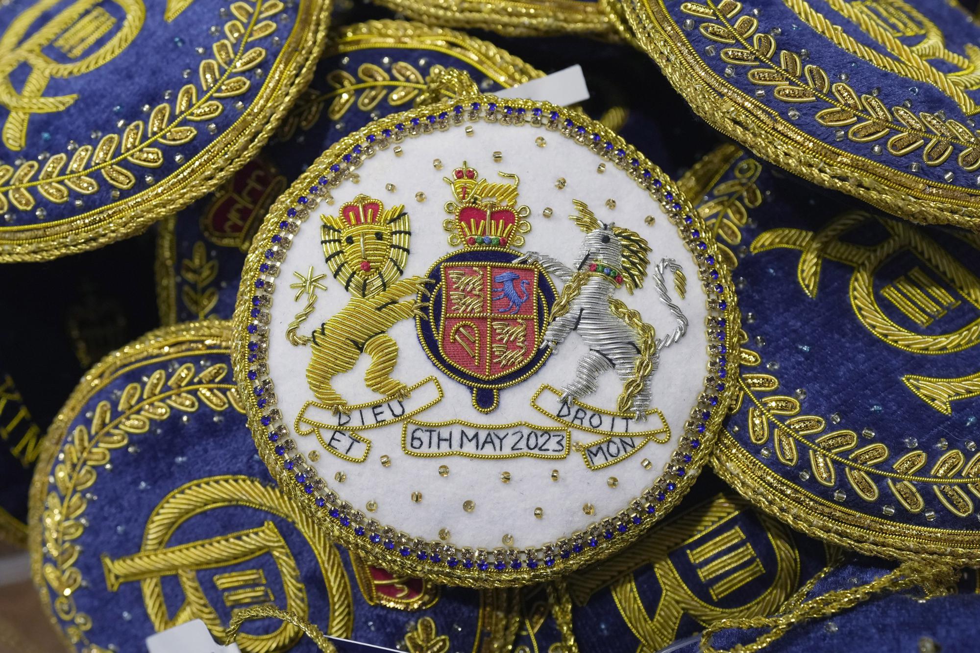 Souvenirs are displayed for sale in a gift shop ahead of King Charles III's Coronation in London, Monday, April 24, 2023. The May 6 coronation is luring royal fans and far-flung visitors fascinated by the ceremonial spectacle — and drama — of the monarchy and eager to experience a piece of British history. Tour companies, shops and restaurants are rolling out the red carpet, whether it's a decked-out bus tour of London's top sights boasting high tea or merchandise running from regal to kitschy. (AP Photo/Kin Cheung)