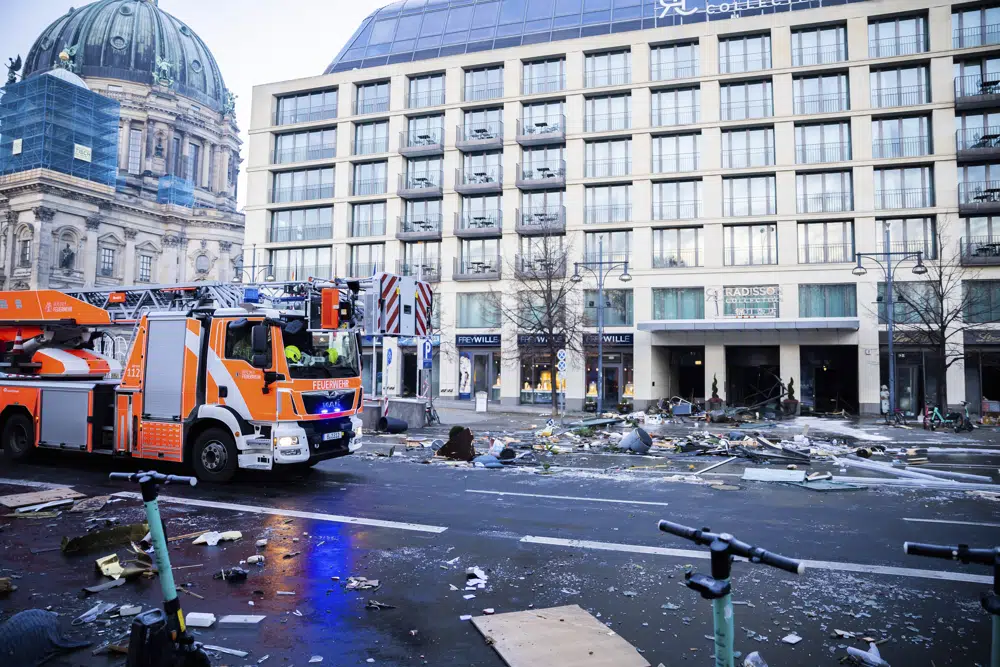 Debris lay on the street after a huge fish tank burst at the Seal Life Aquarium in central Berlin, Germany, Friday, Dec. 16, 2022. (Christoph Soeder/dpa via AP)