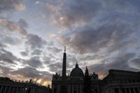 FILE - The sun sets behind St. Peter's Basilica, at the Vatican, Thursday, Dec. 5, 2019. The Vatican’s sprawling financial trial may not have produced any convictions yet or any new smoking guns. But recent testimony in May 2022 has provided plenty of insights into how the Vatican operates. (AP Photo/Gregorio Borgia, File)