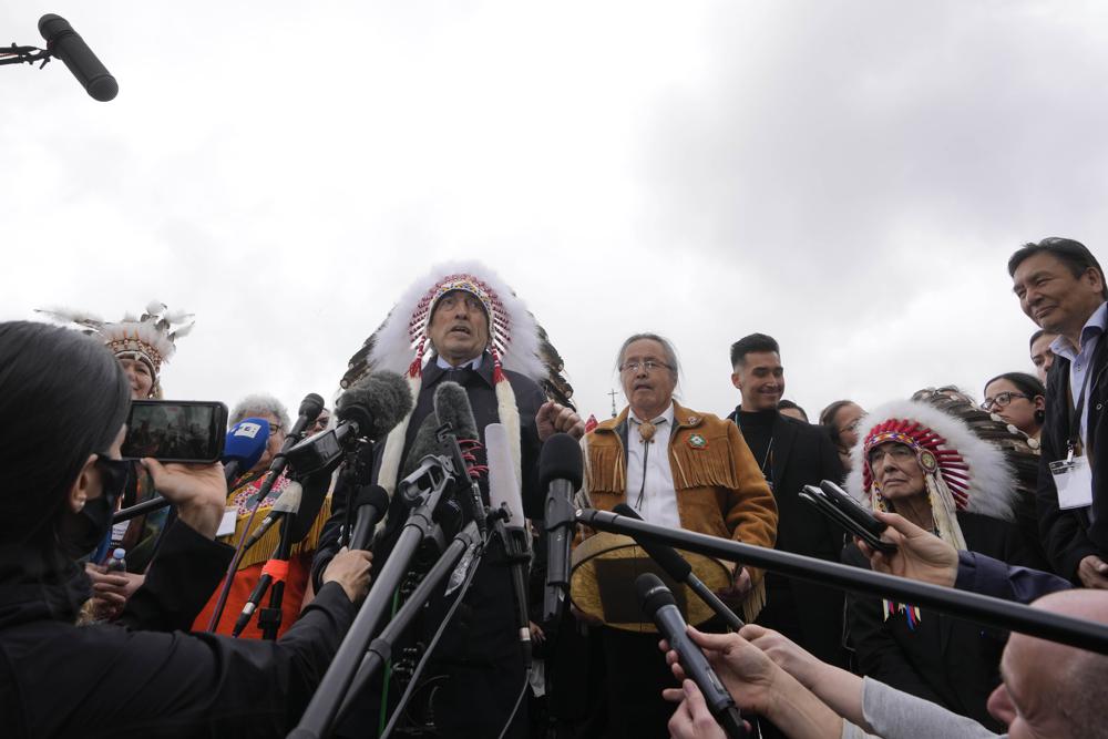 El exjefe Phil Fontaine, centro, flanqueado por el jefe regional de la Asamblea de las Primeras Naciones NWT, Gerald Antoine, habla con los periodistas afuera de la Plaza de San Pedro al final de una reunión con el Papa Francisco en el Vaticano, el jueves 31 de marzo de 2022. (Foto AP /Andrés Medichini)