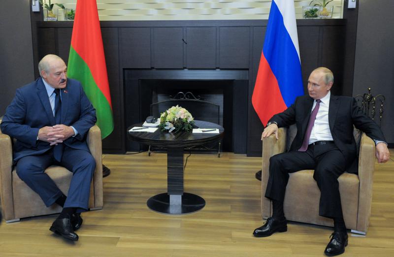 Russian President Vladimir Putin, right, and Belarusian President Alexander Lukashenko talks to each other during their meeting in the Black Sea resort of Sochi, Russia, Friday, May 28, 2021. (Mikhail Klimentyev, Sputnik, Kremlin Pool Photo via AP)