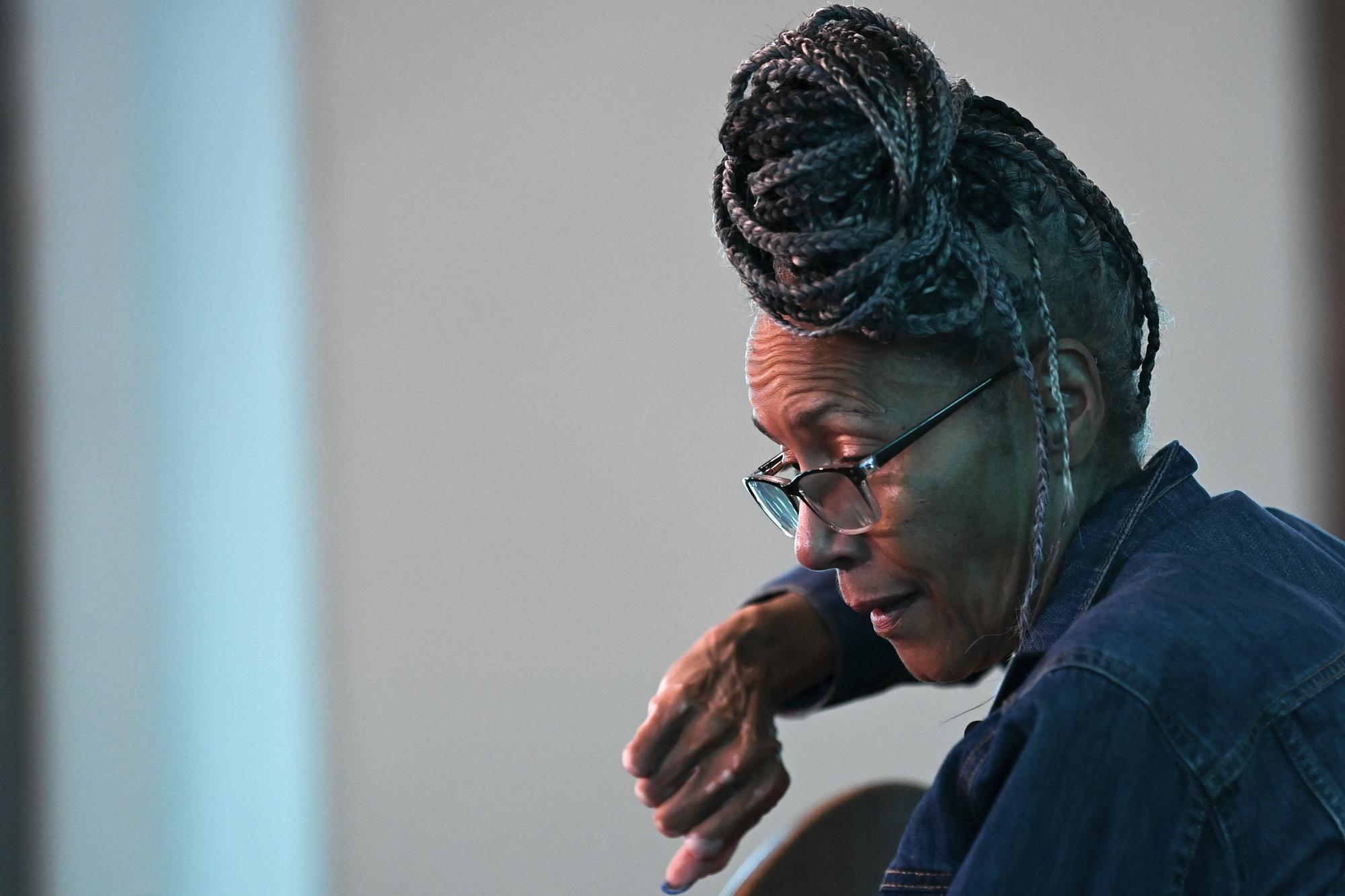 Civil Rights foot soldier Della Simpson Maynor mimics the defensive position she took while being clubbed by police on Feb. 18, 1965, the night activist Jimmie Lee Jackson was fatally wounded, while seated near the scene of the confrontation in Zion Church in Marion, Ala, on May 19, 2023. The 14-year-old Maynor was part of a group planning to march to the Perry County jail where James Orange, a local SCLC field secretary was being held for registering voters. Maynor also heard the gunshots that killed Jackson during the struggle. (AP Photo/Julie Bennett)