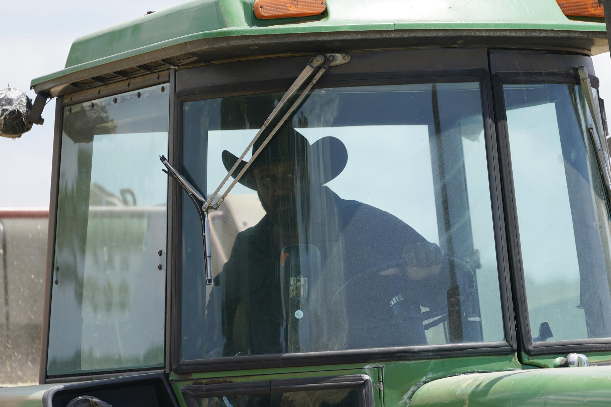 Farmer John Boyd Jr., runs his hay bailer at his farm in Boydton, Va., Thursday, May 27, 2021. (AP Photo/Steve Helber)