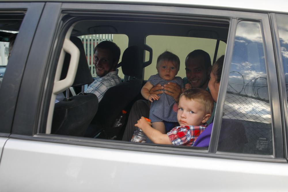 Unidentified people depart on route to the airport from the Christian Aid Ministries headquarters at Titanyen, north of Port-au-Prince, Haiti, Dec. 16, 2021. Twelve remaining members of a U.S.-based missionary group who were kidnapped two months ago have been freed, according to the group and to Haitian police. (AP Photo/Odelyn Joseph)