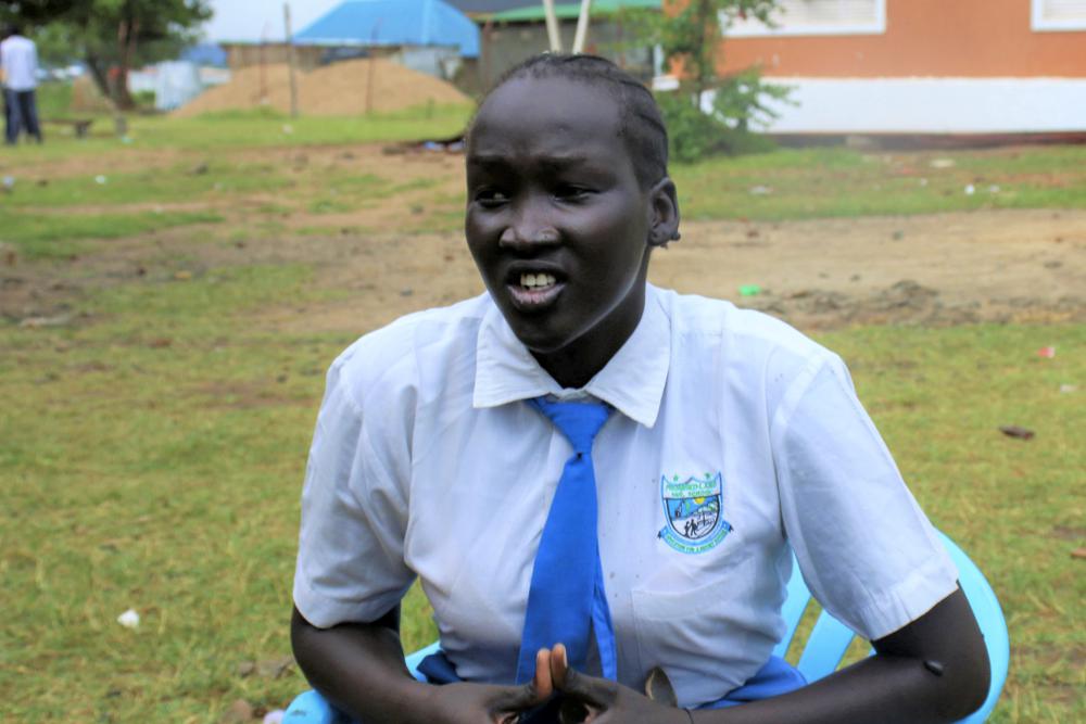 Nyanachiek Madit, 21, who successfully refused when her father told her at age 17 that she would be married off to a man about 50 years old because her family couldn't afford to send her to school, speaks to The Associated Press in Juba, South Sudan on Wednesday, June 8, 2022. Some young girls are auctioned off into marriage for cows in South Sudan - a practice that the government and international organizations are fighting to promote better health and educational opportunities. (AP Photo/Deng Machol)