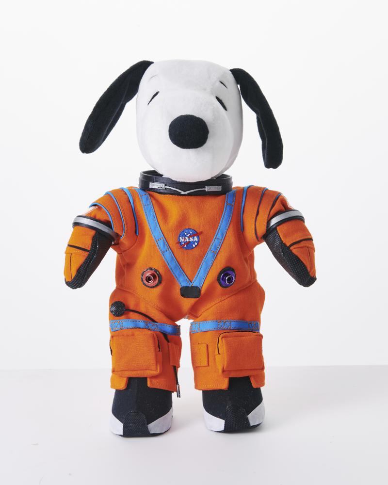 This product image shows a stuffed toy version of Snoopy wearing a NASA space suit. The stuffed toy will be on board the Artemis I unmanned mission next February. NASA uses stuffed animals on flights because when they start to float, it indicates that the spacecraft has entered space’s zero gravity. Since the toys are soft and light, they won’t break anything or accidentally strike a button. (Peanuts Worldwide via AP)