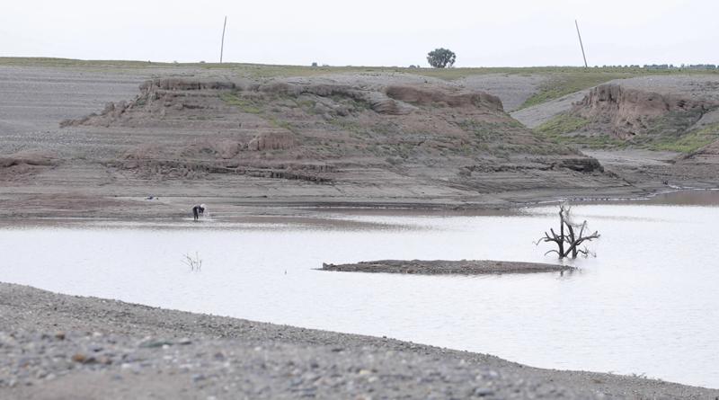 In this photo taken from a video shot on Wednesday, Aug. 4, 2021 in Wad el-Hilu, Sudan, a man washes in the Setit river, known in Ethiopia as Tekeze River. Locals and refugees have pulled dozens from bodies from the river separating Ethiopia’s troubled Tigray region from Sudan in the past week, many with bullet wounds and their hands bound. Witnesses say that they are ethnic killings committed by Ethiopian government forces of Tigrayans, and that the bodies are being dumped to conceal the evidence. There was no immediate comment from the Ethiopian government but it has denied ethnic killings in the past.  (AP Photo/Mohaned Awad)