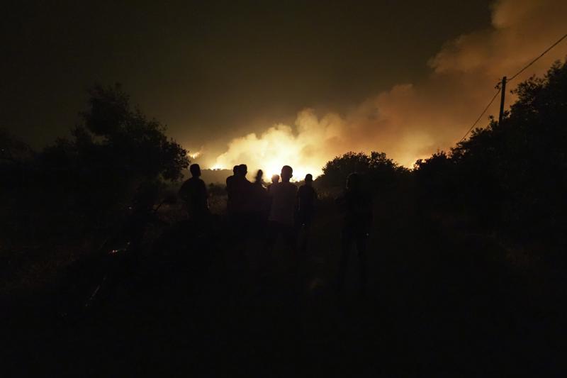 Flames burn a forest during a wildfire in Skepasti village on the island of Evia, about 150 kilometers (93 miles) north of Athens, Greece, Thursday, Aug. 5, 2021. Forest fires fueled by a protracted heat wave raged overnight and into Thursday in Greece, threatening the archaeological site at the birthplace of the modern Olympics and forcing the evacuation of dozens of villages. (AP Photo/Thodoris Nikolaou)