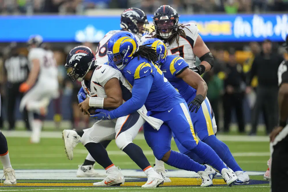 Los Angeles Rams' Terrell Lewis sacks Denver Broncos quarterback Russell Wilson during the first half of an NFL football game between the Los Angeles Rams and the Denver Broncos on Sunday, Dec. 25, 2022, in Inglewood, Calif.(AP Photo/Marcio J. Sanchez)