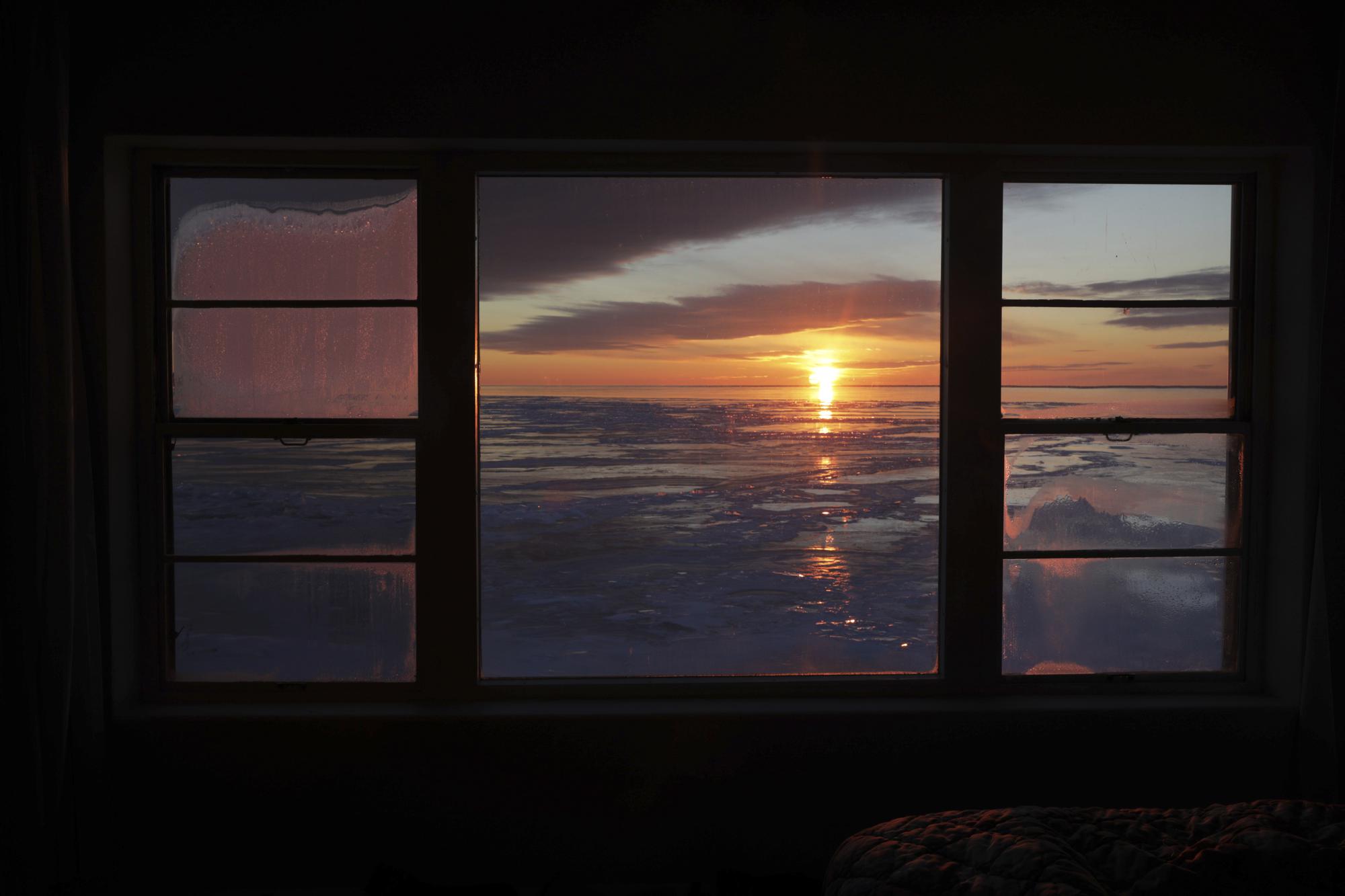 The sun rises over icy Lake Superior in Grand Marais, Minn., on March 3, 2022. (AP Photo/Emma H. Tobin)