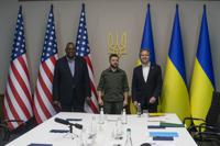 In this image provided by the Department of Defense, Secretary of Defense Lloyd Austin, left, and Secretary of State Antony Blinken, right, meet with Ukrainian President Volodymyr Zelenskyy, Sunday, April 24, 2022 in Kyiv, Ukraine. (Department of Defense via AP)