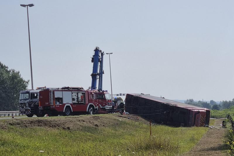 Emergency crews work at the site of a bus accident near Slavonski Brod, Croatia, Sunday, July 25, 2021. A bus swerved off a highway and crashed in Croatia early Sunday, killing 10 people and injuring at least 30 others, police said. (AP Photo/Luka Safundzic, SBonline)