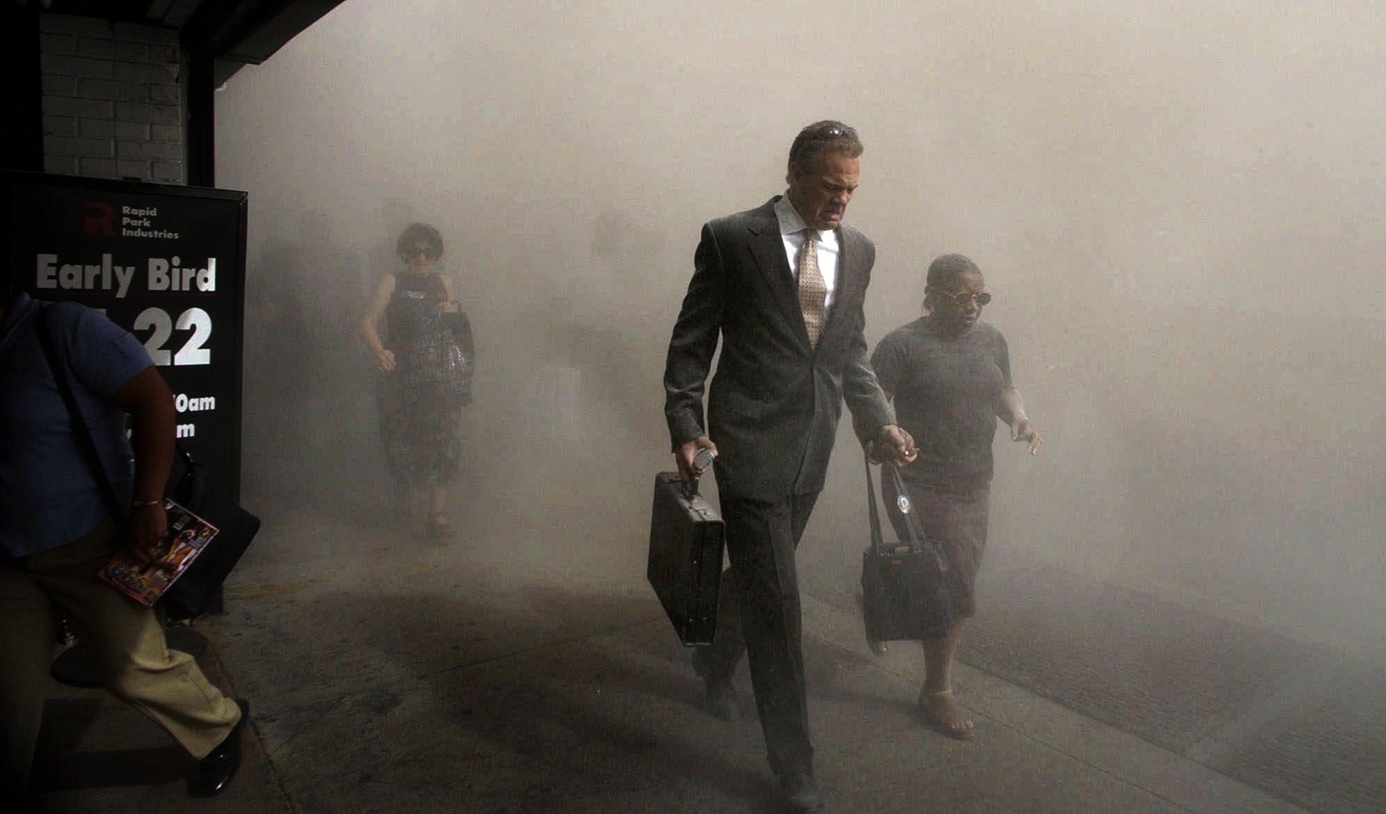 Pedestrians flee the area of New York's World Trade Center in lower Manhattan on Tuesday, Sept. 11, 2001. (AP Photo/Amy Sancetta)