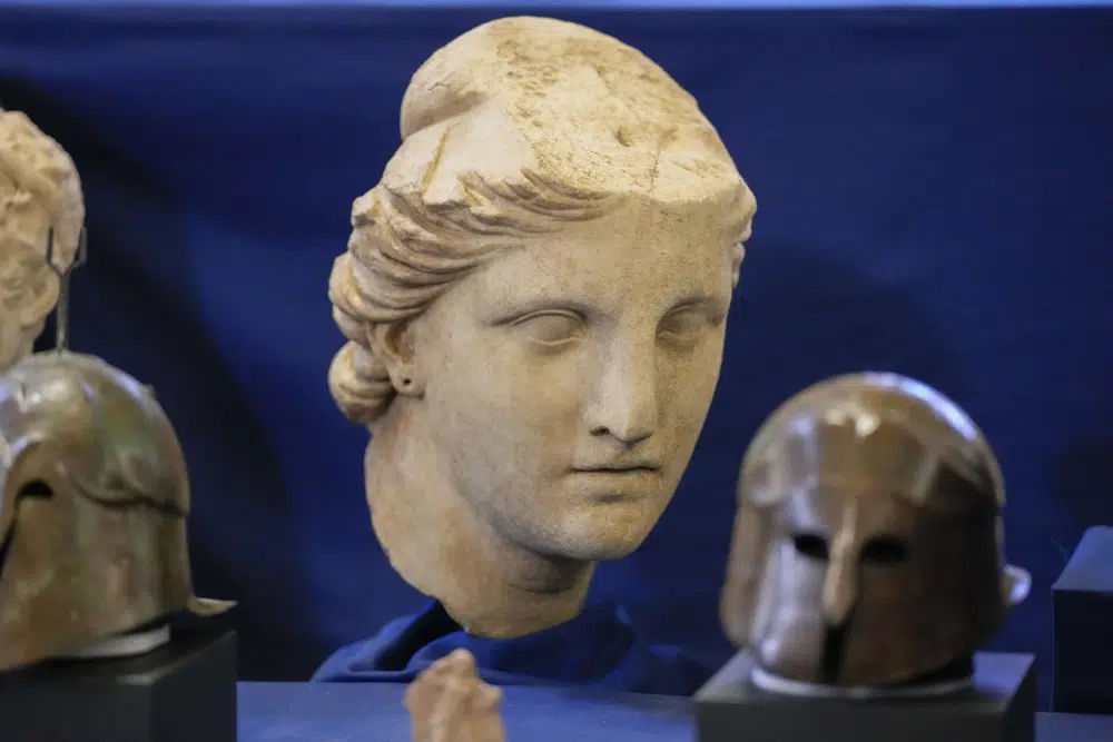 A marble head of Atena, dated to the II century B.C., is seen on display among other archaeological artifacts stolen from Italy and sold in the US by international art traffickers, during a press conference in Rome, Monday, Jan. 23, 2023. 60 stolen artifacts, for an estimated total value of 20 million dollars, have been recovered in private collections in the US and returned to Italy after a joint investigation by Italian Carabinieri police and the New York County District Attorney's Office. (AP Photo/Andrew Medichini)