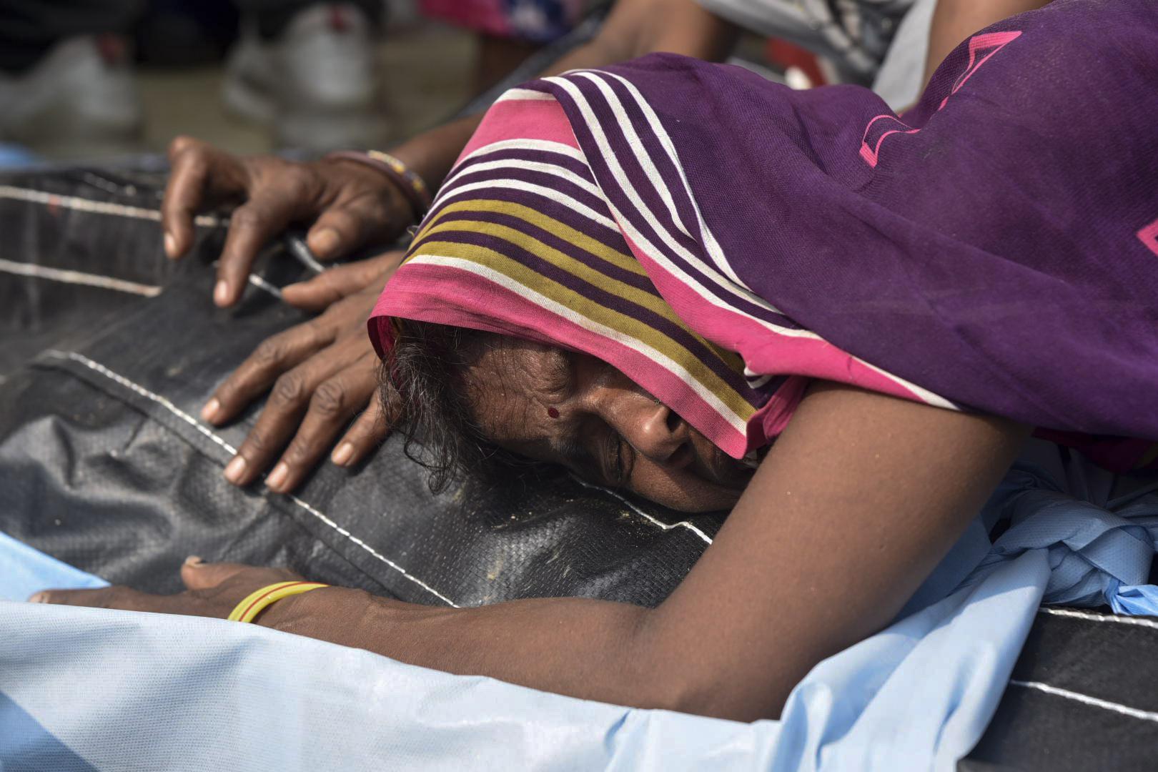 Farm vehicle packed with people overturns in India; 26 dead