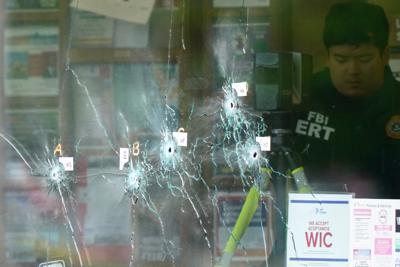 FILE - An investigator works at the scene after a mass shooting at a supermarket, in Buffalo, N.Y., May 16, 2022. A white man who gunned down 11 at the supermarket shared his anti semitic rants on Gab, a site that attracts extremists. (AP Photo/Matt Rourke, File)
