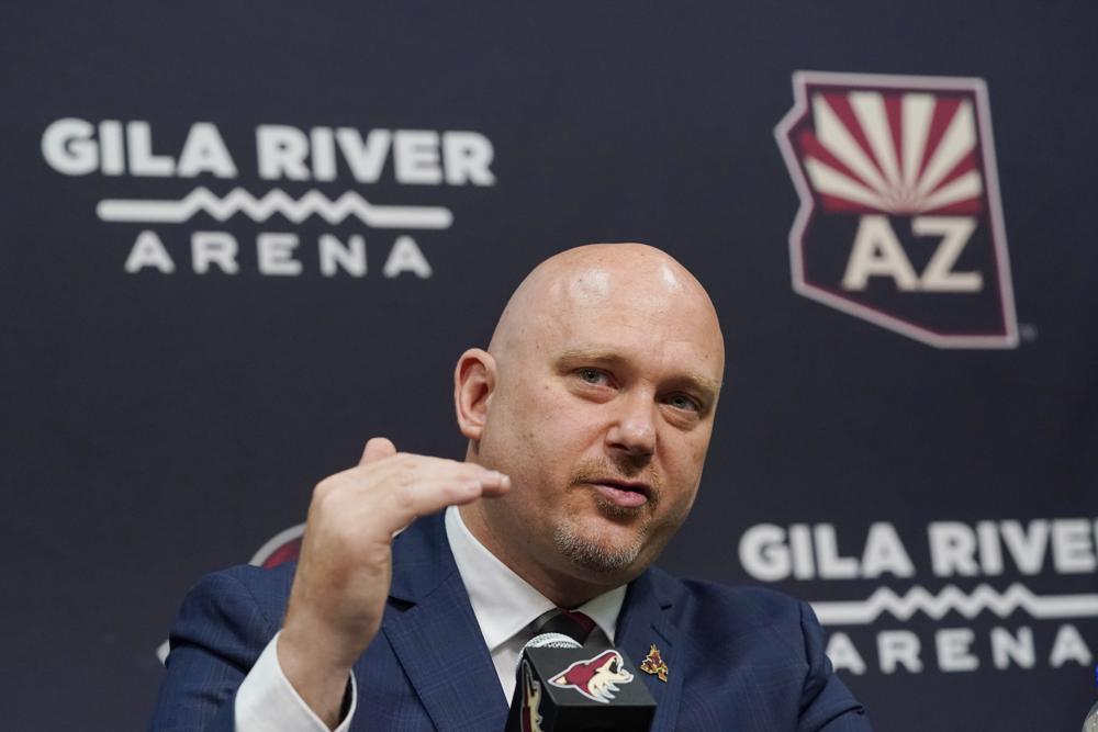 FILE - In this July 1, 2021, file photo, Arizona Coyotes          new head coach Andre Tourigny speaks during an NHL hockey news          conference at Gila River Arena in Glendale, Ariz. The Coyotes          are in their second year of rebuilding under Tourigny after          finishing with the NHL's second-worst record a year ago. (AP          Photo/Ross D. Franklin, File)